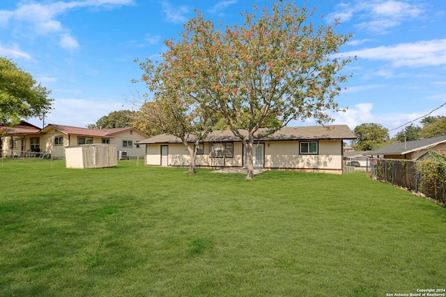 rear view of property featuring a yard