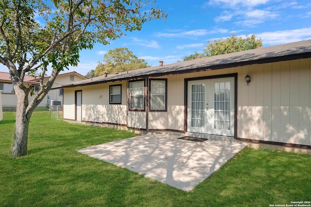 back of house featuring a patio and a lawn