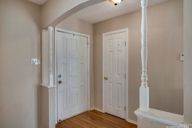 entrance foyer with wood-type flooring and a textured ceiling