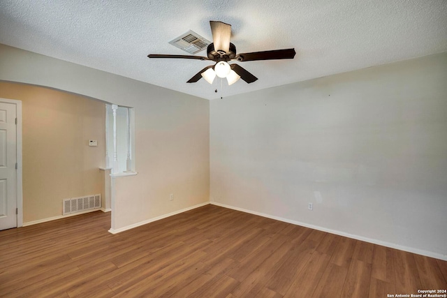 unfurnished room featuring ceiling fan, wood-type flooring, and a textured ceiling