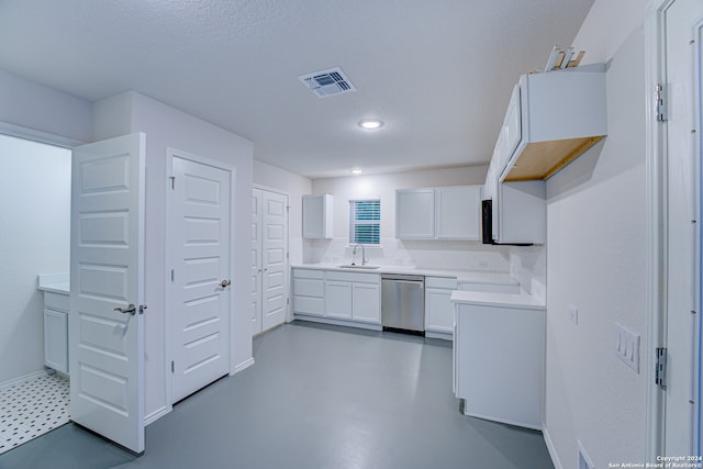 kitchen featuring dishwasher, a textured ceiling, white cabinetry, and sink