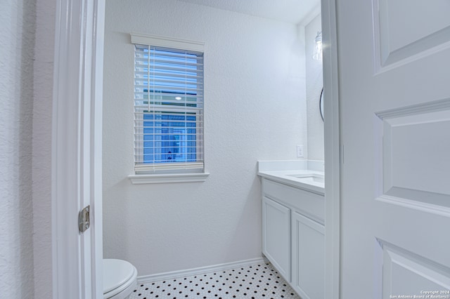 bathroom featuring tile patterned floors, vanity, and toilet