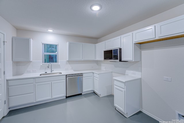 kitchen featuring white cabinets, sink, stainless steel appliances, and tasteful backsplash