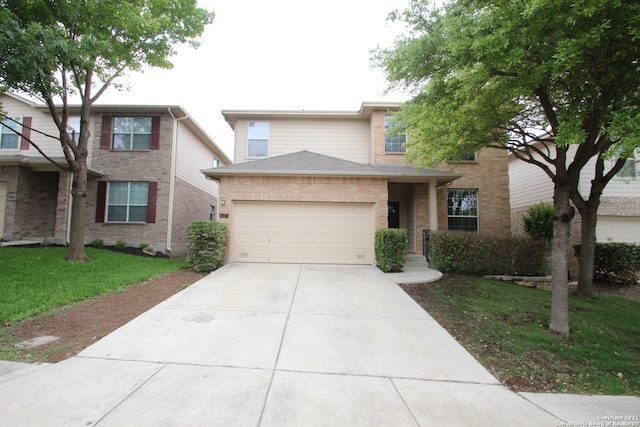 view of front of property featuring a front lawn and a garage