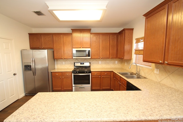 kitchen featuring stainless steel appliances, decorative backsplash, sink, and dark hardwood / wood-style flooring