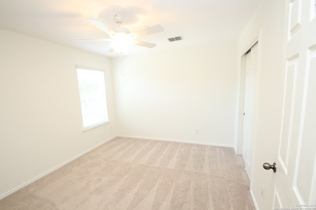 carpeted empty room with ceiling fan