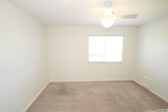 carpeted empty room with ceiling fan