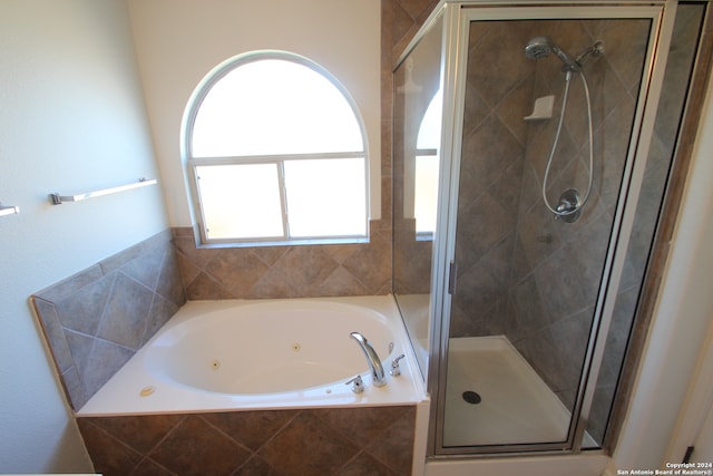 bathroom featuring shower with separate bathtub