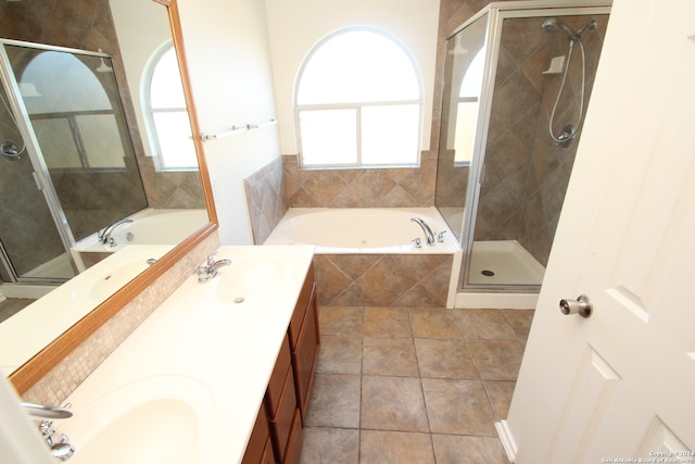 bathroom featuring vanity, tile patterned flooring, and plus walk in shower