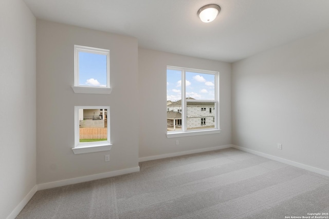 unfurnished room featuring light carpet