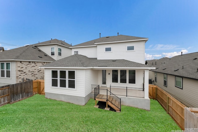 rear view of property featuring a yard