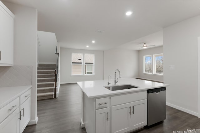 kitchen featuring sink, white cabinetry, dishwasher, ceiling fan, and a kitchen island with sink