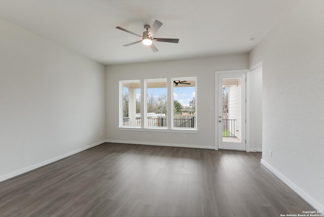 spare room featuring dark hardwood / wood-style flooring and ceiling fan