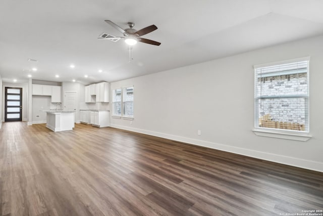 unfurnished living room featuring hardwood / wood-style floors and ceiling fan