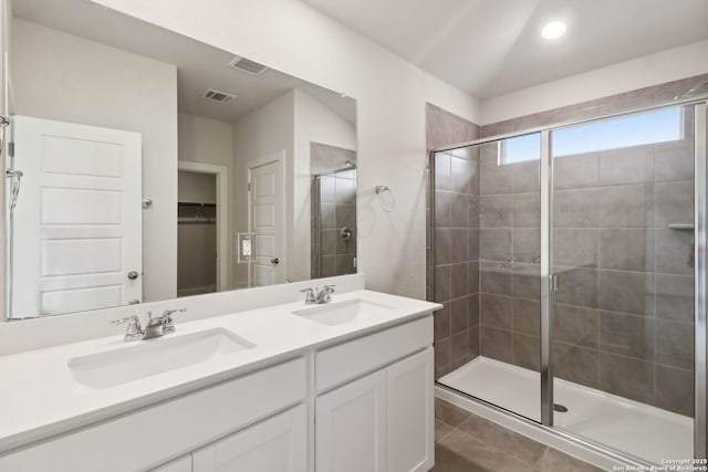 bathroom featuring walk in shower, tile patterned floors, and vanity