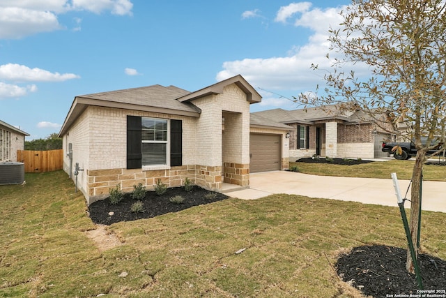 view of front of house with central AC, a garage, and a front lawn