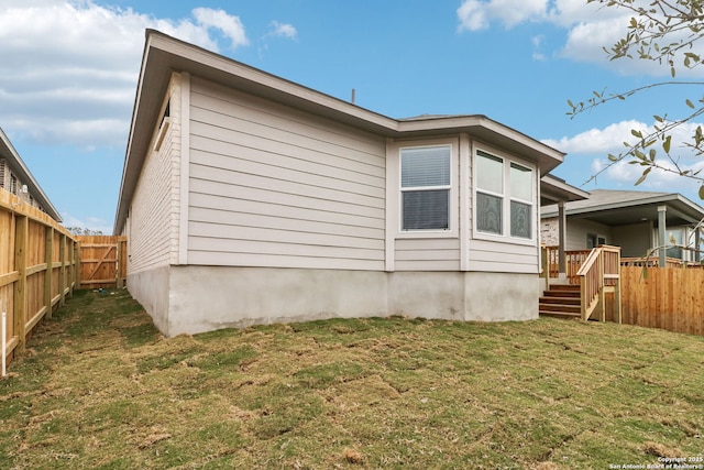 view of property exterior featuring a lawn