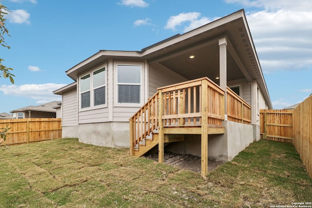 back of house featuring a yard and a deck