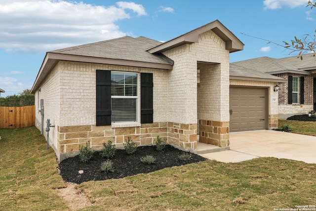 view of front facade with a garage and a front lawn