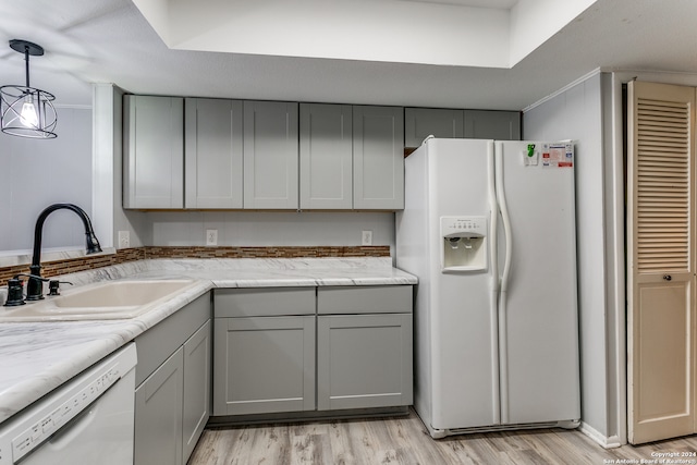 kitchen with white appliances, sink, light wood-type flooring, and gray cabinets