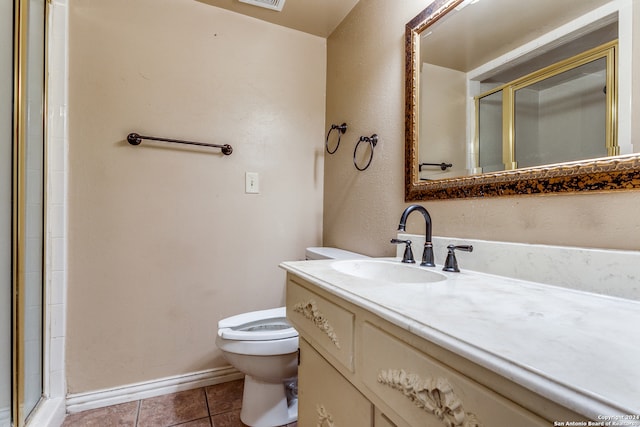 bathroom with vanity, a shower with shower door, toilet, and tile patterned flooring