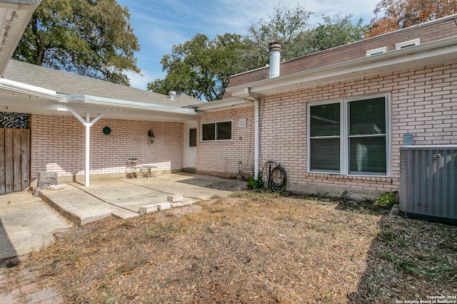 rear view of property with a patio area and central AC unit