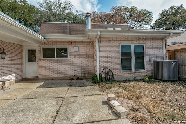 rear view of property featuring a patio area and central AC unit