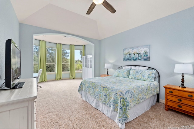 carpeted bedroom with ceiling fan and vaulted ceiling