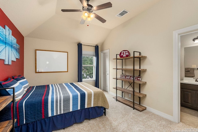 carpeted bedroom with lofted ceiling, sink, ceiling fan, and ensuite bath