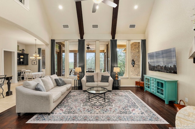 living room featuring beamed ceiling, high vaulted ceiling, ceiling fan with notable chandelier, and dark hardwood / wood-style flooring