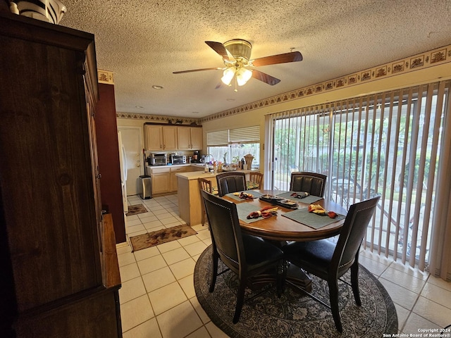 8414 Glen Breeze, San Antonio, TX 78239 - dining area with light tile patterned floors, a ceiling fan, and a textured ceiling