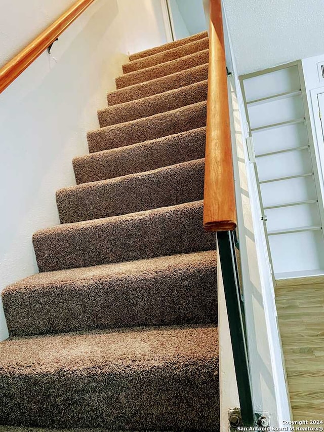 stairs with hardwood / wood-style flooring