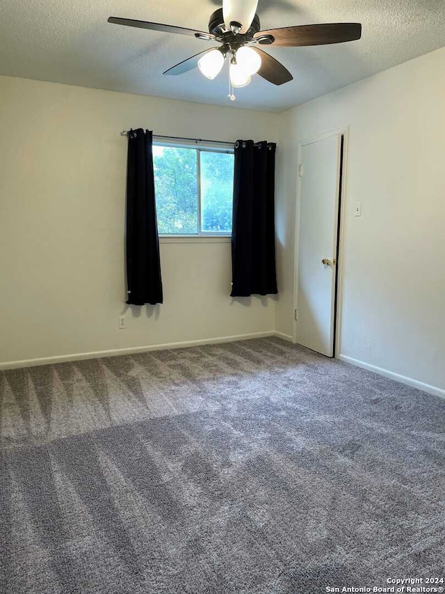 unfurnished room featuring ceiling fan, carpet, and a textured ceiling