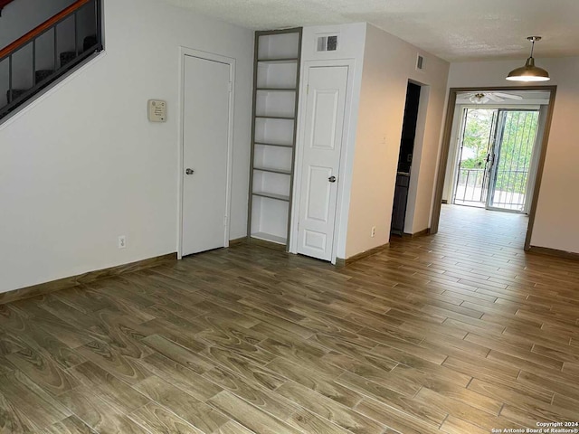 empty room featuring hardwood / wood-style floors and a textured ceiling