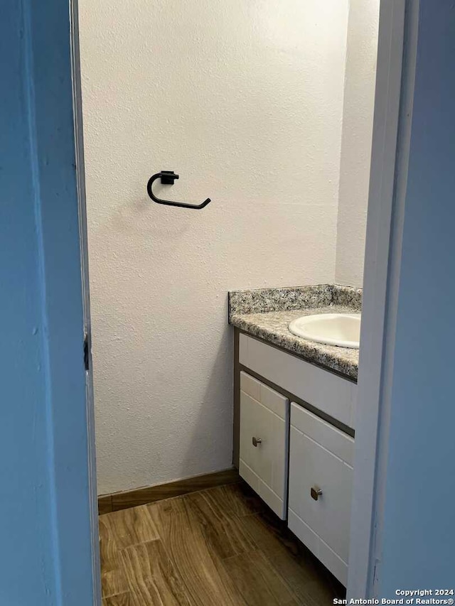 bathroom with vanity and hardwood / wood-style flooring