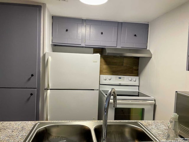 kitchen featuring white appliances and sink