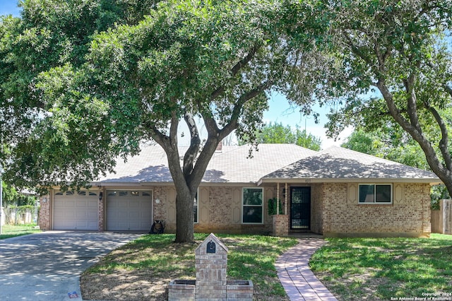 single story home featuring a front yard and a garage