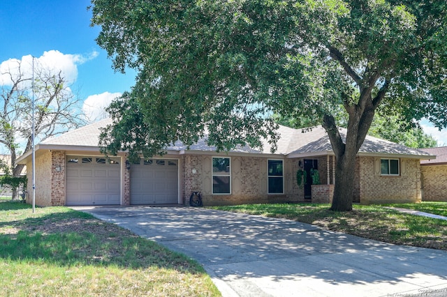 ranch-style home with a garage and a front lawn