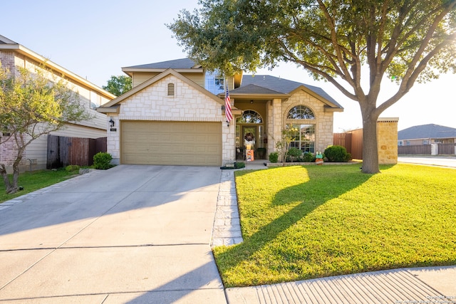 view of front of home with a front yard and a garage