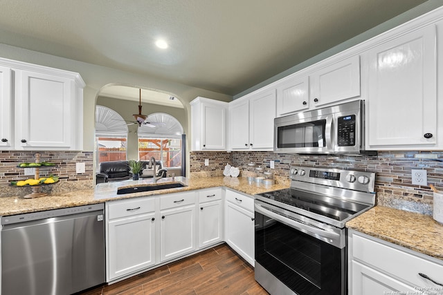 kitchen with sink, white cabinets, dark wood-type flooring, and stainless steel appliances