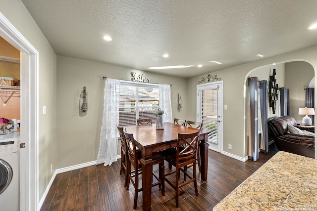 dining room with washer / dryer, dark wood-type flooring, and a textured ceiling