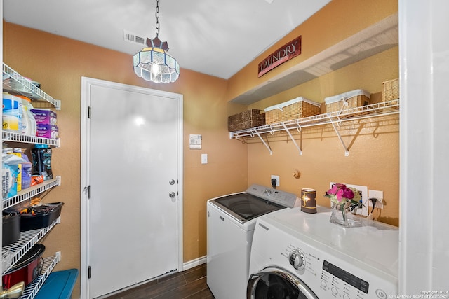 laundry room featuring washer and clothes dryer and dark hardwood / wood-style flooring