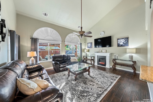 living room with ceiling fan, high vaulted ceiling, and dark hardwood / wood-style flooring