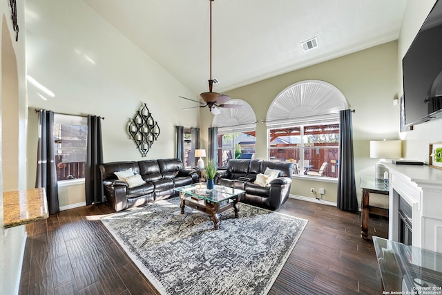 living room featuring ceiling fan, high vaulted ceiling, and dark hardwood / wood-style flooring