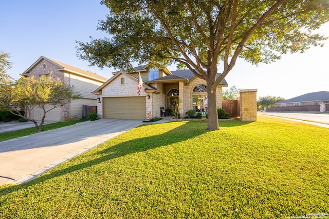 view of front of home featuring a front yard and a garage