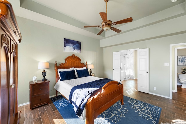 bedroom with connected bathroom, dark wood-type flooring, and ceiling fan