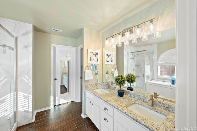 bathroom featuring vanity, wood-type flooring, and walk in shower