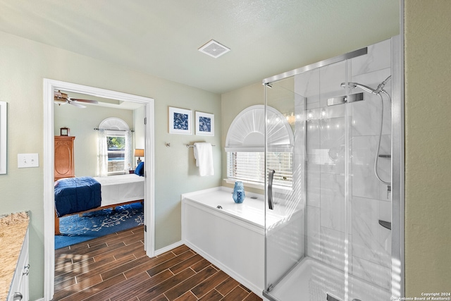 bathroom with a shower with door, hardwood / wood-style flooring, vanity, and ceiling fan