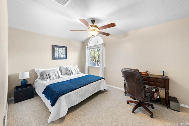 bedroom with light carpet, a textured ceiling, and ceiling fan