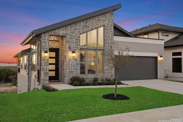 contemporary home with a yard and a garage